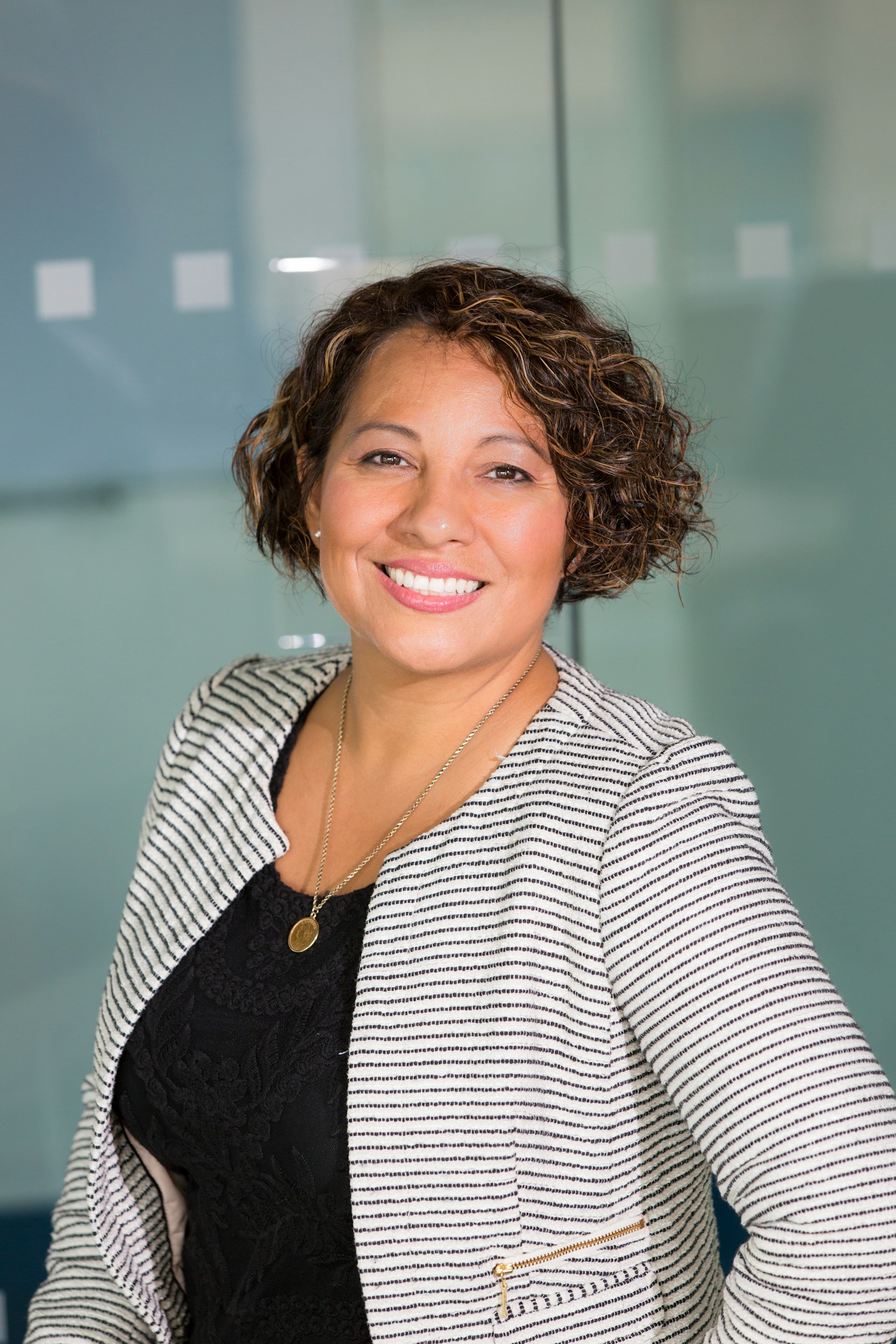 Professional woman in business attire smiling at camera