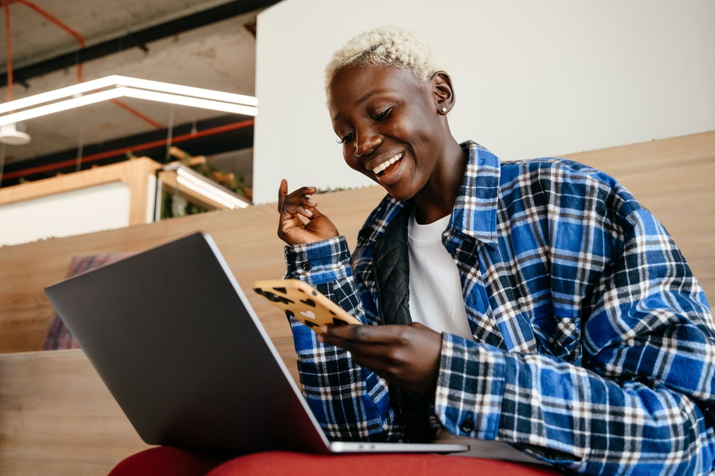 Smiling woman using a smartphone indoors